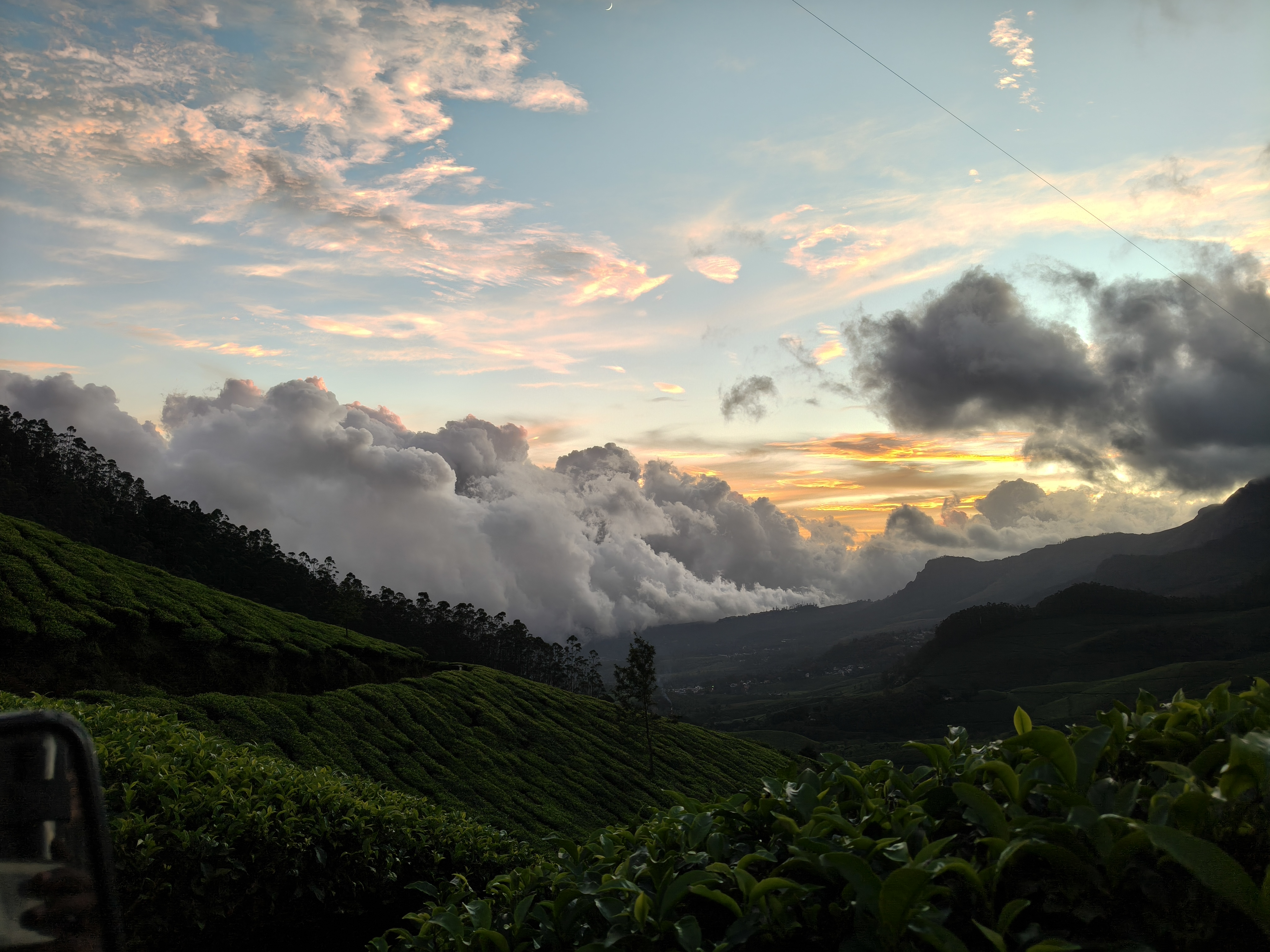 Kolukkumalai sunrise clouds and glowing sky above tea plantation hills